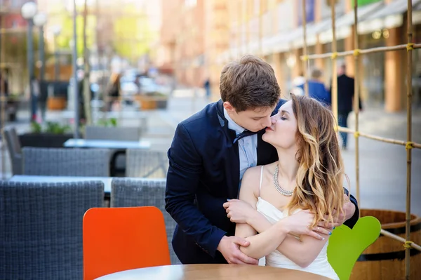 Groom kisses the bride on walk in wedding day — Stock Photo, Image