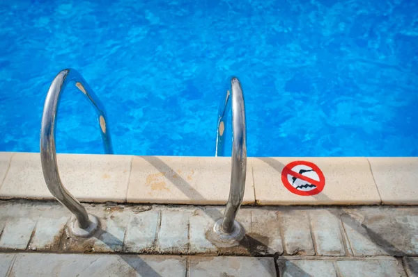 Swimming pool with stair at hotel close up Royalty Free Stock Images