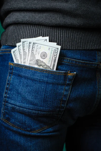 Dollar bills sticking out of the pocket of a man — Stock Photo, Image