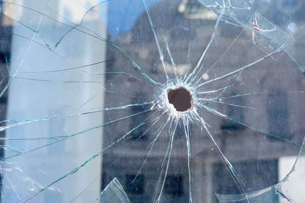 Holes from shots in the shop window — Stock Photo, Image