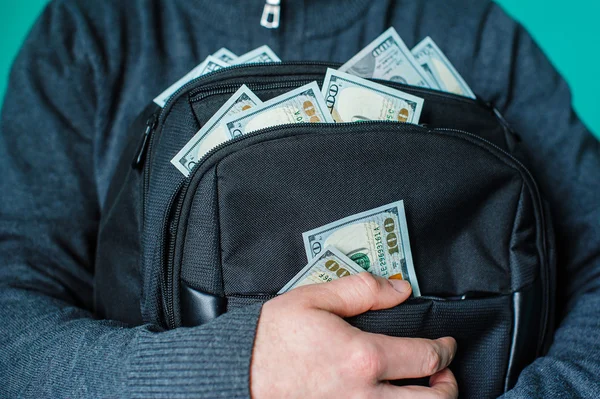 Man holding a black briefcase with dollars — Stock Photo, Image