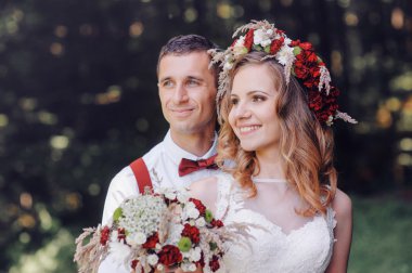 happy bride and groom walking in spring day