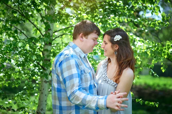 Young happy couple in love walking in the park — Stock Photo, Image