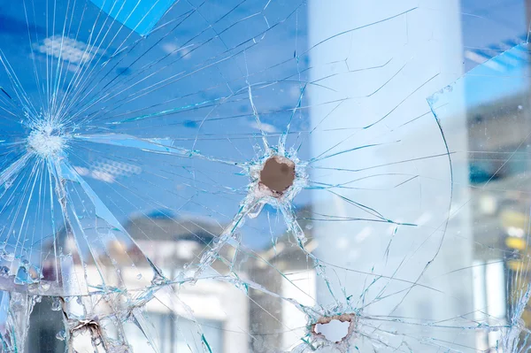 Bullet holes in the window of the shop — Stock Photo, Image