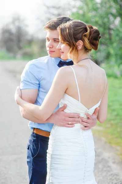 Bride and groom at wedding Day hugging Outdoors on spring nature — Stock Photo, Image