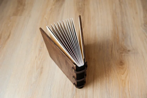 Photo book in a brown wooden cover — Stock Photo, Image