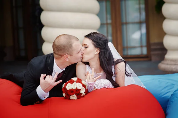 Happy bride and groom showing their rings on hands — Stock Photo, Image