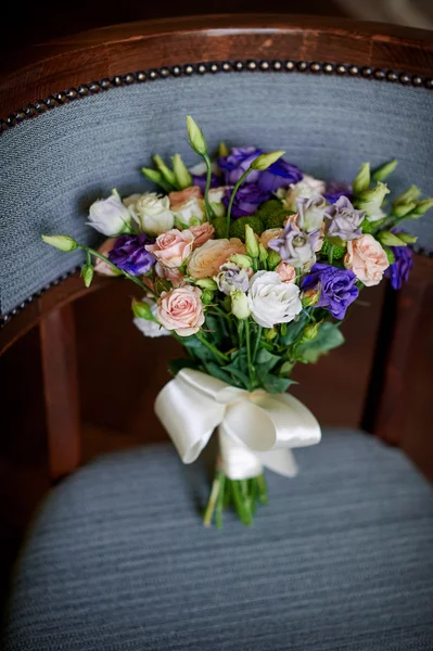 Pink and purple flowers in wedding bridal bouquet on chair — Stock Photo, Image