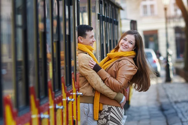 Feliz pareja amorosa posando cerca de un tranvía en la ciudad Lviv — Foto de Stock