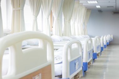 Hospital ward with beds and medical equipment clipart