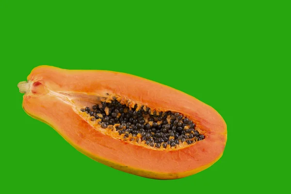 Fruta de mamão meia madura com sementes isoladas em fundo verde brilhante. Espaço de cópia — Fotografia de Stock