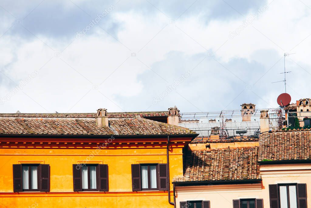 House with old tiled roof . Chimney on the rooftop