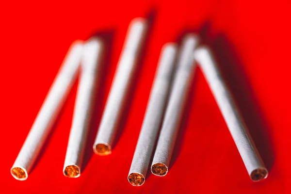 Cigarettes on a red background . Smoking bad habit