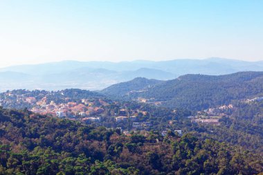 Vallvidrera Reservoir in Barcelona . View of green mountains . Luxury district at natural reserve 