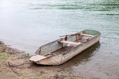 Kürekli paslı metal bir tekne. Balıkçı köyü 