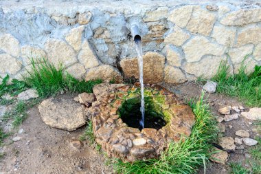 Fresh water spring . Source of underground freshwater clipart