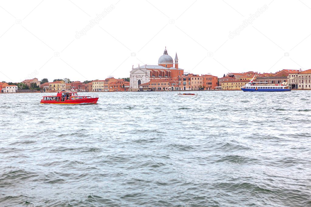 View of Giudecca island in Venice Italy . Overlooking an island in the Venetian Lagoon . Boat tour on Grand Canal . Le Zitelle church