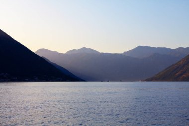 Dağların ve lagünün üzerinde gün batımı. Akşamları Kotor Körfezi 