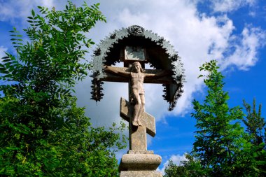 Jesus on the Cross , stone statue . Christ monument 