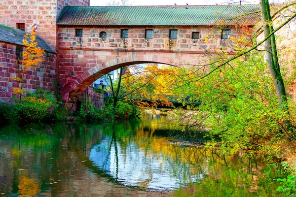 Arch bridge over the river . Autumn in Germany . Pegnitz river and arched bridge in Nuremberg