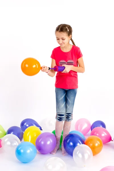 The girl inflates a balloon pump — Stock Photo, Image