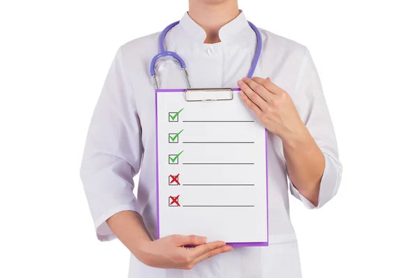 The doctor shows a sheet of paper for recording, cross and check mark, isolated background. — Stock Photo, Image