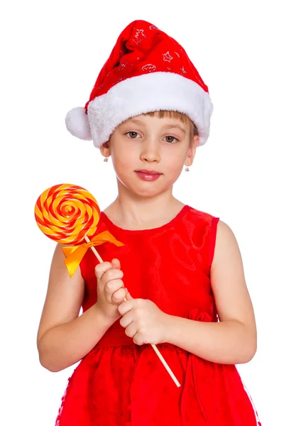 Menina feliz em santa chapéu com cana de doces de Natal — Fotografia de Stock