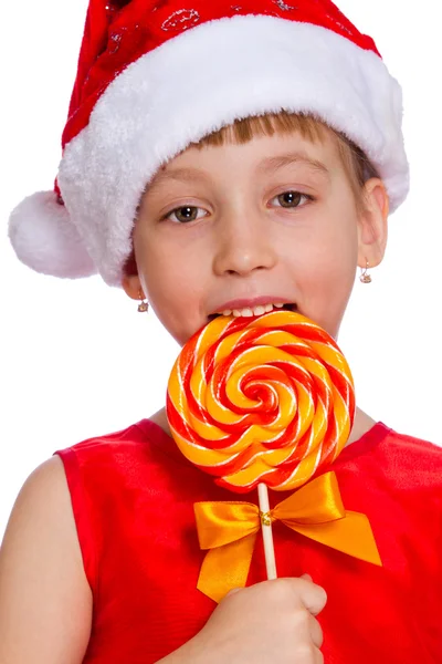 Menina feliz em santa chapéu com cana de doces de Natal — Fotografia de Stock