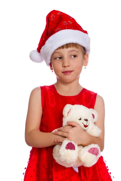 Girl in a red cap holding a toy in the hands, isolated Royalty Free Stock Images