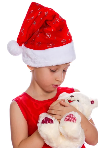 Girl in a red cap holding a toy in the hands, isolated — Stock Photo, Image