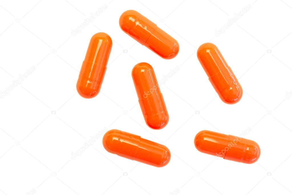 Doses of medicines in bright gelatin capsules isolated on white