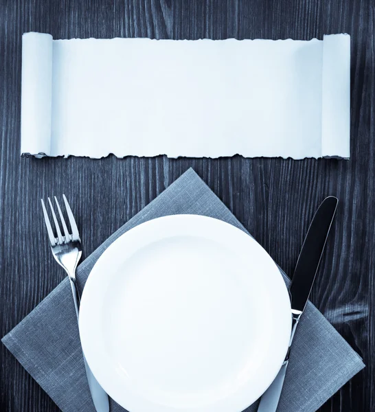 Kitchen utensils at cloth napkin on wood — Stock Photo, Image