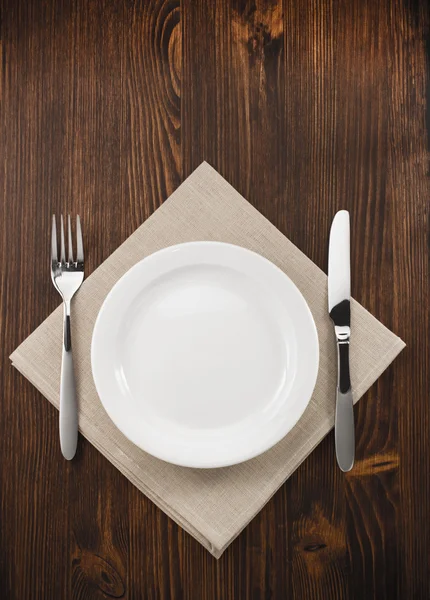 Plate, knife and fork  on wood — Stock Photo, Image