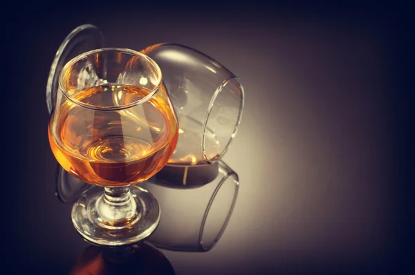 Cognac and  glass  on black — Stock Photo, Image