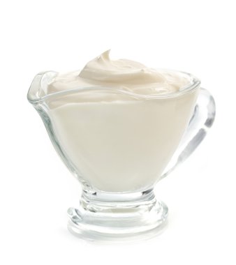sour cream in bowl on white  clipart