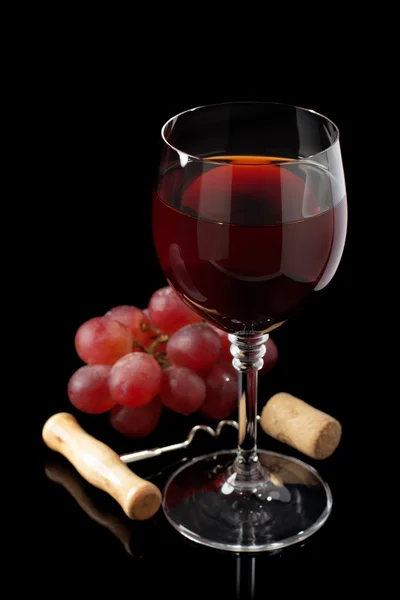 Wine glass and grapes on black — Stock Photo, Image