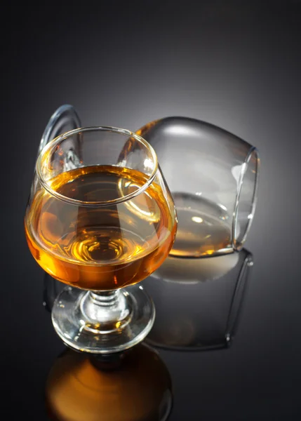 Brandy in glass on black — Stock Photo, Image