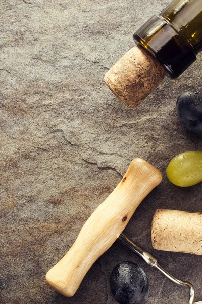 Corkscrew and wine bottle with grape — Stock Photo, Image