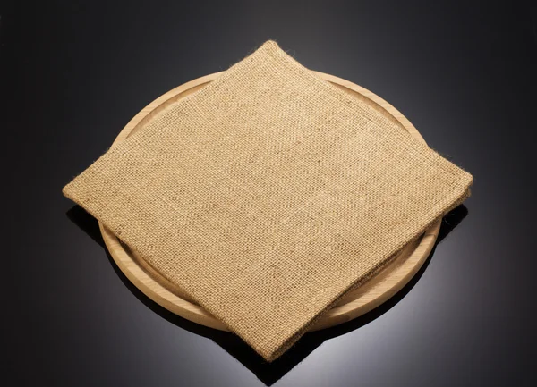 Sack burlap napkin at cutting board — Stock Photo, Image