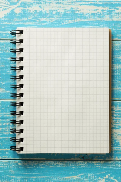 Checked notebook on wood — Stock Photo, Image