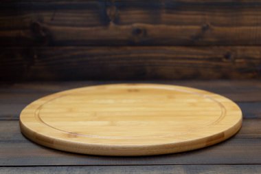 pizza cutting board at wooden table, with wood background texture