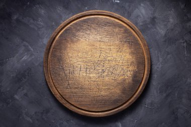 pizza cutting board at  table or wall, with stone background texture