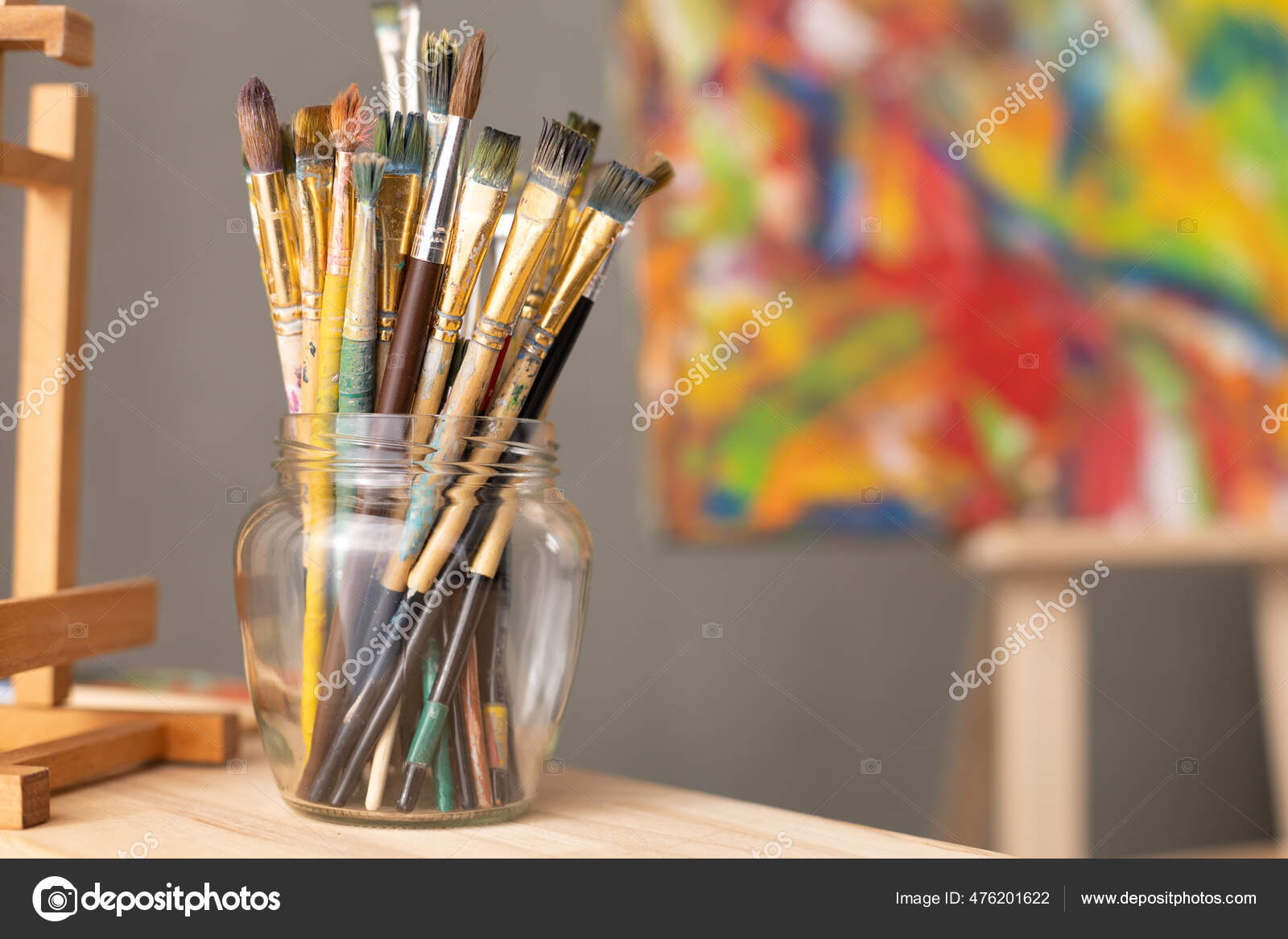 Paint brush in clay jug and palette on wooden table background. Oil painting  and art still life Stock Photo by seregam