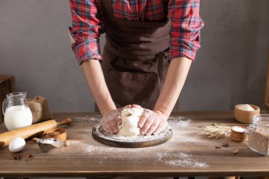 Aşçı adam masada ev yapımı ekmek pişirmek için hamur ve fırın malzemeleri yapıyor. Fırın konsepti ve erkek eli