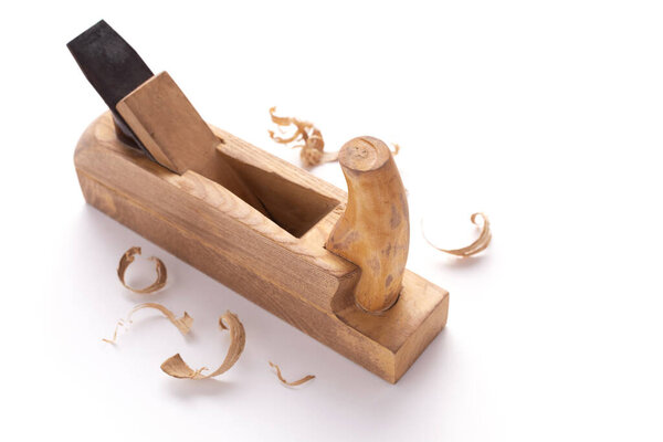 Plane tool for carpenter or joiner and wooden shavings isolated on white background. Woodworking tools for Jointer