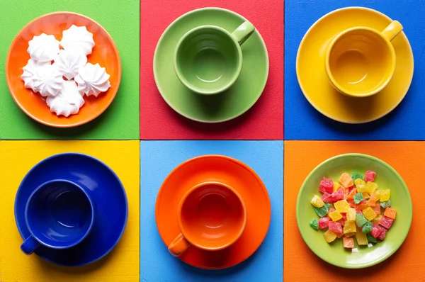 Empty cup and candied  fruit at colorful abstract background texture. Coffee break time concept. Crockery set