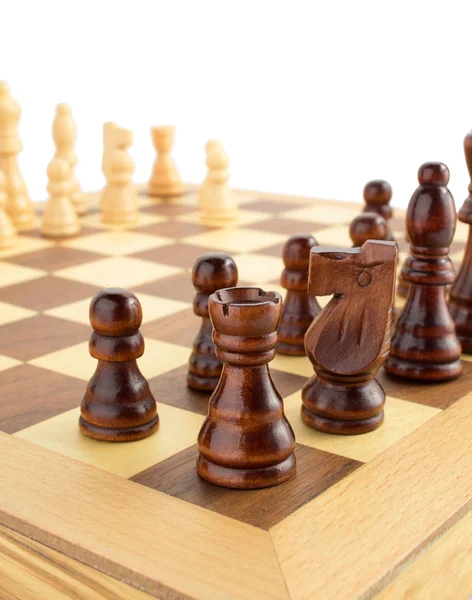 Chess figures on board at white — Stock Photo, Image