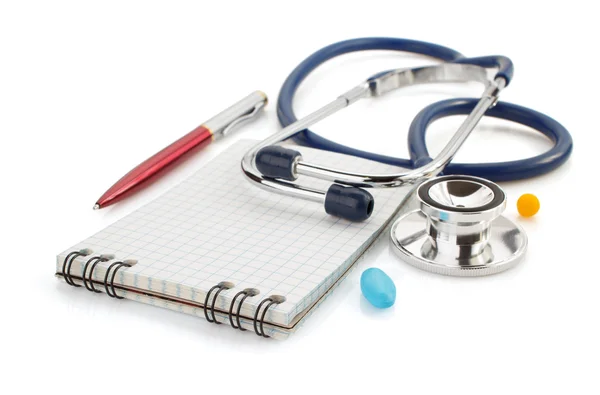 Stethoscope and notebook on white — Stock Photo, Image