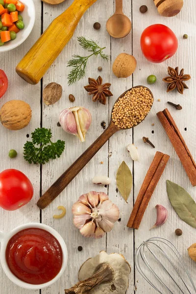 Herbs and spices on wooden background — Stock Photo, Image