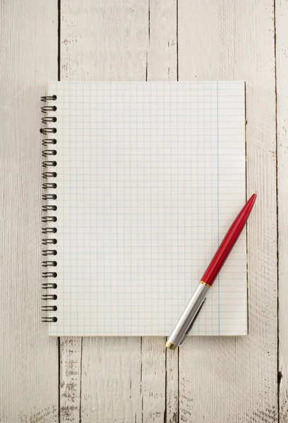 Checked notebook on wood Stock Image